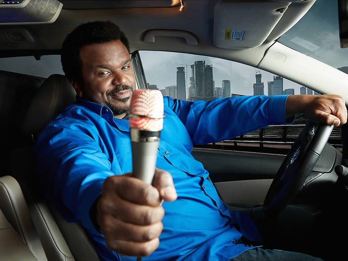 Craig Robinson holding microphone in "Caraoke Showdown" promo