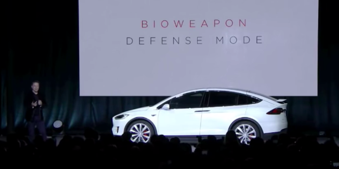 Elon Musk in front of Tesla car discussing Bioweapon Defense Mode