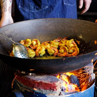 Image may contain Human Person Food Dish Meal Stew Wok and Frying Pan